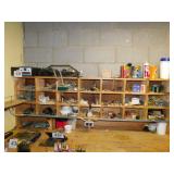 Wood cubby holes full of hardware and repair parts