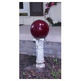 Red glass gazing ball on pedestal stand, 24' tall