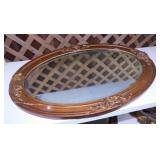 Antique oval beveled mirror in ornate frame,