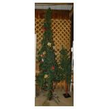 2 slender primitive lighted Christmas trees,