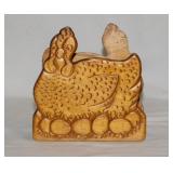 Kitschy carved wood hen on nest chicken