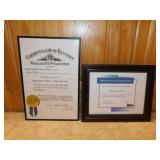Several award plaques and framed certificates