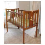 Vintage wooden toy baby doll bed with mattress on