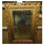 Antique beveled mirror in gilded ornate frame,