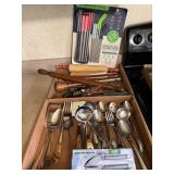 Box containing stainless steel serving utensils,