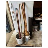 2- 5 gallon buckets containing, 5 corn brooms, 2