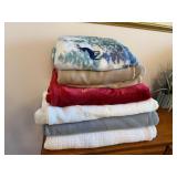7 Blankets of Various Colors and Sizes