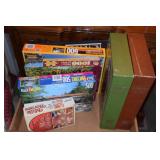 Lot containing various board games & puzzles.