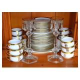 12 place setting of dinnerware with 2 candle