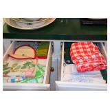 2 drawers containing kitchen towels, pot holders,