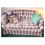 Upholstered couch, pillows & throw golf blanket.