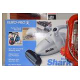 3 shelves containing Shark Hand turbo vacuum,