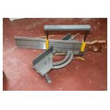 2 shelves containing Craftsman handsaw guide,