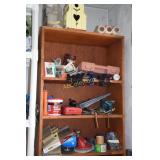 Wooden shelf containing sand paper, clamps, hand