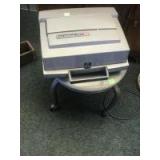 Rolling stool on casters and a Kodak Instamatic M 80 Projector Rolling stool on casters and a Kodak Instamatic M 80 Projector