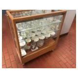 Wooden Showcase on casters, with glass shelves. Wooden Showcase on casters, with glass shelves.
