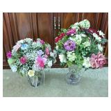 Pair of floral arrangements in vases. 1 floral