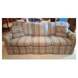 Vintage fabric sofa with stripes, and cushions.