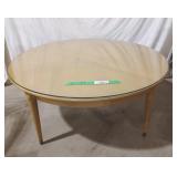 Wooden circular Coffee Table with a glass on the