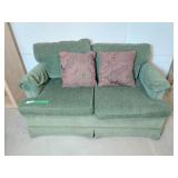 Green love seat with 2 throw pillows - clean