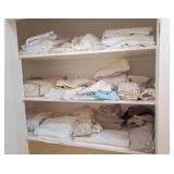 Assorted towels, bedding, table clothes, and