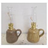 Pair of pottery oil lamps with handles. Signed