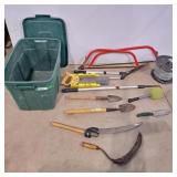 Bin with lid  with garden tools 2 bow saws, wire,