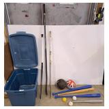 Bin with volleyball, assorted hockey sticks,