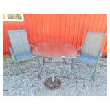 Patio table with 2 chairs and 1 umbrella stand.