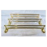 Trio of brass towel racks