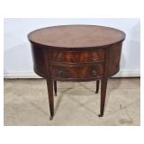 Lovely leather top oval side table, featuring two
