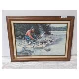 L. Gibbs framed fishing on a rocky riverbank