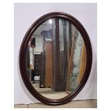 Gibbard oval mirror features a rich mahogany