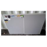 Wall mounted cabinet with white board.