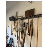 ALL OF THE YARD TOOLS HANGING & A FEW RIGHT BELOW
