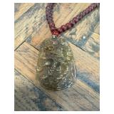 Carved Jade Stone Pendant on Red Beaded Necklace