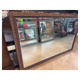 Wood-Framed Mirror with Ornate Decoration