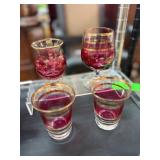 Four Red and Gold-Toned Glassware Items