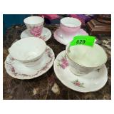 Four Assorted Porcelain Teacups and Saucers with F