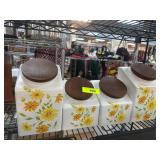 Four Ceramic Canisters with Floral Design