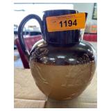 Two-Tone Ceramic Jug with Embossed Figures