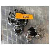 Two Skull-Themed Metal Items with Flame Details