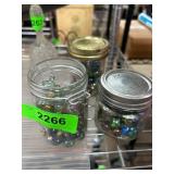 Three Jars Containing Multicolor Glass Marbles
