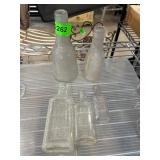 Five Embossed Glass Bottles