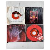 Four Vinyl 45 RPM Records with Sleeves