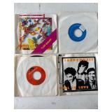 Four 45 RPM Vinyl Records with Sleeves