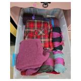 Folded Textiles in Plastic Storage Bin