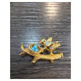 Gold-Tone Bird and Nest Brooch With Blue Accents