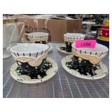 Four Black and White Ceramic Tea Cups and Saucers