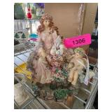 Porcelain Figurine of Woman and Cherub